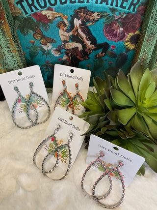 This image displays a pair of intricately designed teardrop earrings, aptly named "Castle Rock Stone Teardrop Earrings." The earrings are crafted with a vibrant, multicolored array of stones set in a metallic frame, adding a touch of elegance.