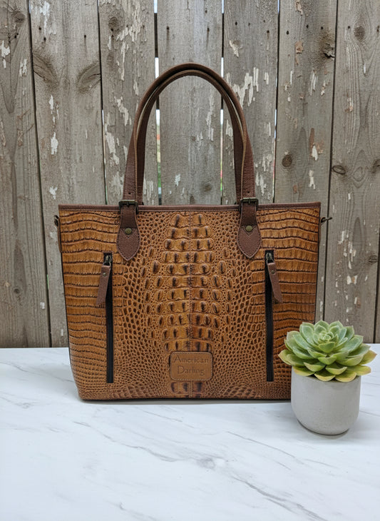 Brown crocodile-embossed leather tote with double straps, removable tassels, and detachable crossbody strap