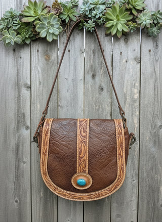 Hand tooled western leather handbag with turquoise stone accent and antique finish