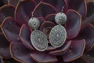 Silver-tone western drop earrings with intricate etched pattern and double-disc design on French hooks.