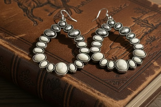 Silver-tone hoop earrings with white oval stones arranged around the hoop and small bead accents.