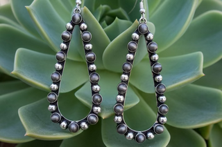 Silver-tone teardrop earrings with textured beaded detail and burnished silver-tone accents