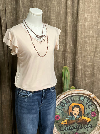 Image of the cream-colored Elaine Ruffle Top featuring a flattering V-neckline and delicate ruffle sleeves, crafted from luxuriously soft fabric for an effortlessly elegant look