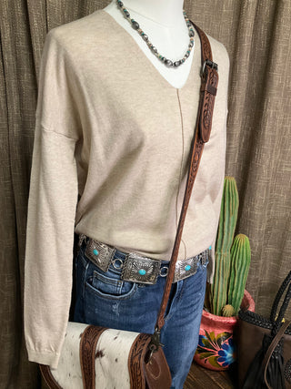 Women’s neutral v-neck sweater with exposed front seam and split hem in oatmeal and grey