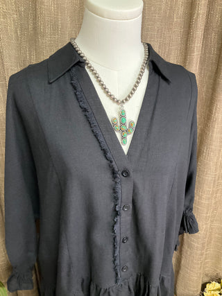 Harlie Linen Top in a lightweight, breathable linen fabric featuring a button-up front, 3/4 sleeves, and a ruffled bottom hem with frayed edging for a relaxed yet chic look. Designed for versatile styling across seasons.