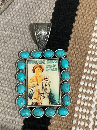 Closeup of pendant featuring vintage Buffalo Bill poster surrounded by faux turquoise stones