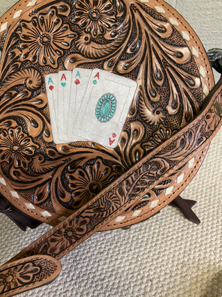 Genuine leather tooled canteen bag with hand-painted Aces, turquoise concho, rawhide stitching, and adjustable tooled strap