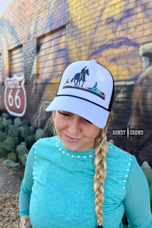 white and black trucker cap with horseback cowboy in desert scene