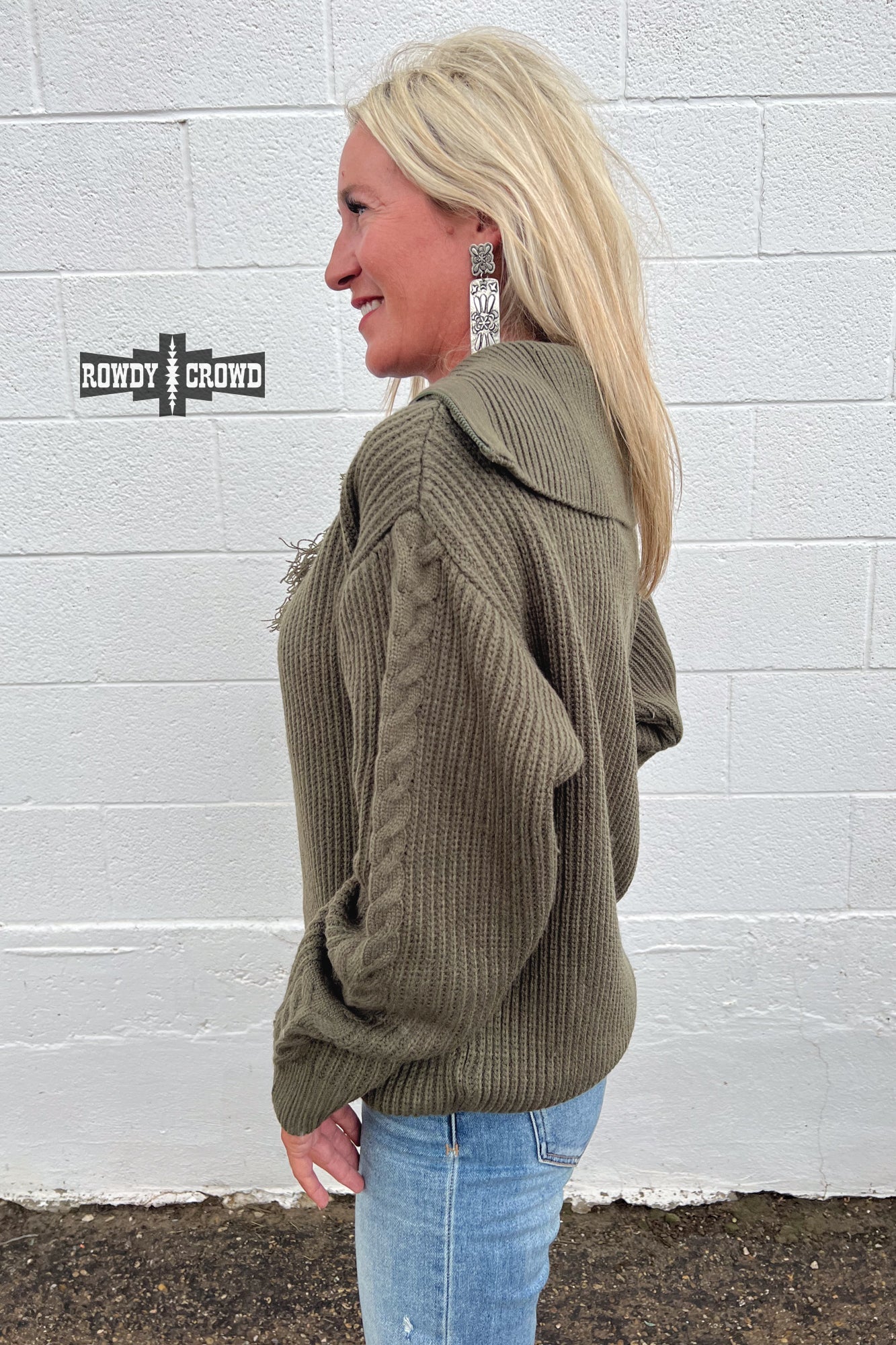 olive quarter zip pullover sweater with frayed accent at base of zipper and cable knit stripe down sleeve