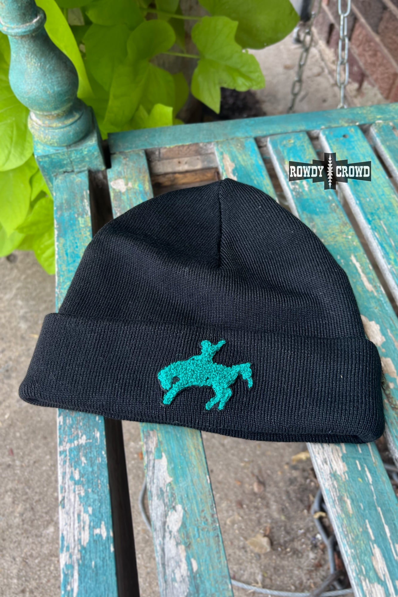 black beanie hat with turquoise cowboy riding bucking horse