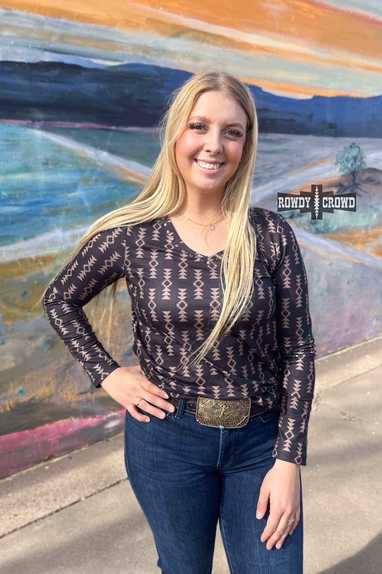 black long sleeve v neck top with tan Aztec print and concho accents at neckline