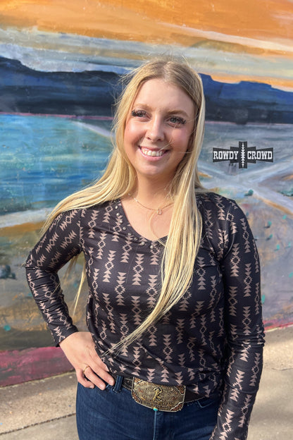 black long sleeve v neck top with tan Aztec print and concho accents at neckline