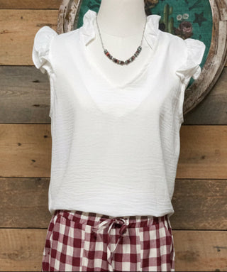 Women's V-neck blouse with ruffle shoulder details and relaxed fit
