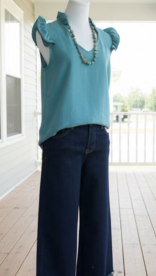Women's casual blouse styled with denim and layered jewelry