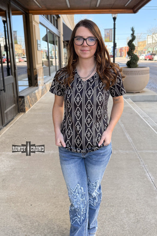 Pecos Queen Top with a bold, southwest-inspired Aztec print and a soft v-neck design. Crafted from a soft, stretchy polyester-spandex blend. True to size fit.