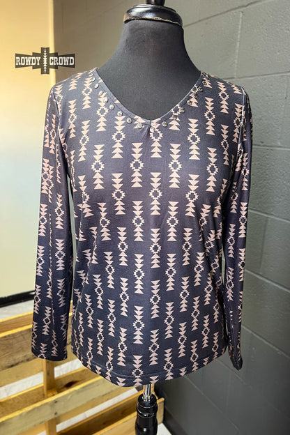 black long sleeve v neck top with tan Aztec print and concho accents at neckline