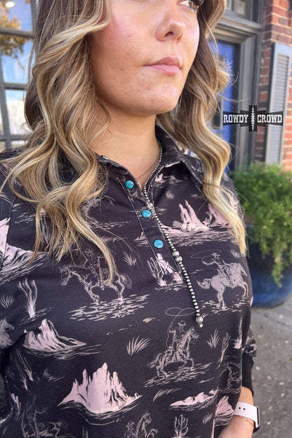 black collared long sleeve top with cream colored cowboy on horse pattern with mountains.  cuff sleeve and bottom. three turquoise snaps