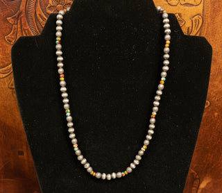Silver toned beaded necklace with textured beads and multicolor stone-look accent beads