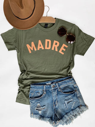 Women's Madre graphic t-shirt styled with denim shorts and western accessories

Alt Text 3