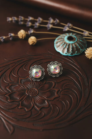 Silver-tone floral stud earrings with aurora borealis crystal center