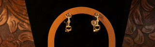 Gold snaffle bit hoop earrings with a polished equestrian-inspired design