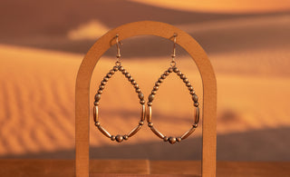 Lightweight copper-tone teardrop earrings with polished bead detailing
