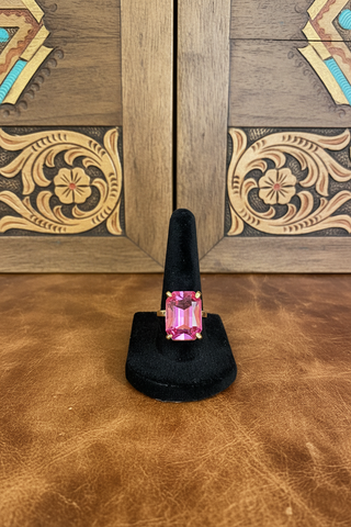 Adjustable cocktail-style ring featuring a sparkling faceted stone