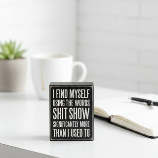 Funny black box sign with white lettering featuring humorous shit show quote home décor gift