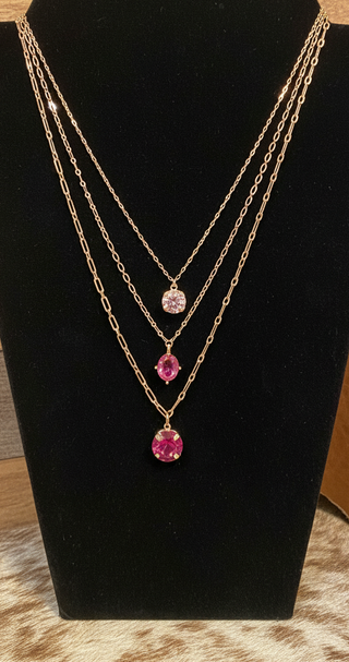 Water resistant triple layered gold necklace with pink crystal pendants and matching stud earrings