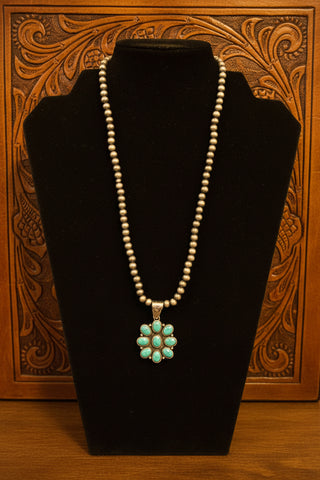 Silver toned beaded necklace with faux turquoise floral pendant